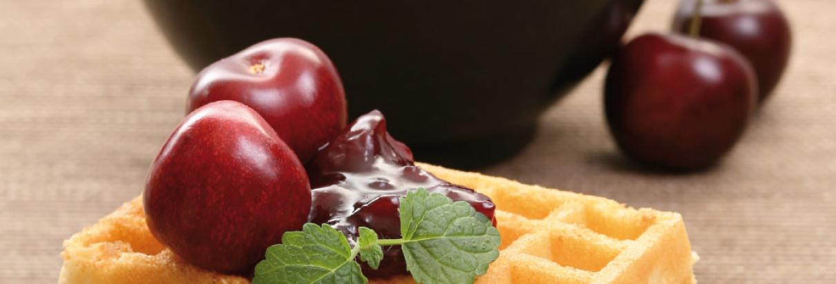 Waffels with morello cherries in a fruits of the forest sauce